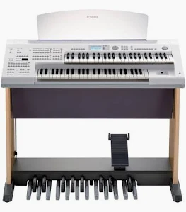 A child sitting at a keyboard in music class
